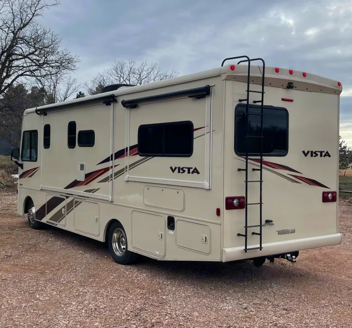 This cream-colored Winnebago Vista motorhome, a perfect RV rental, is ready for your adventure.. Winnebago Vista 2018