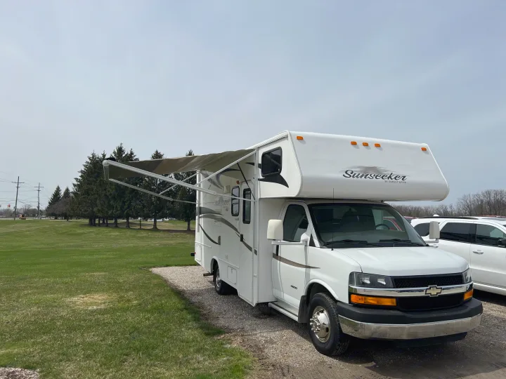 White Sunseeker RV motorhome with extended awning, parked for your next rv rental or camping trip.. Forest River Sunseeker LE 2013