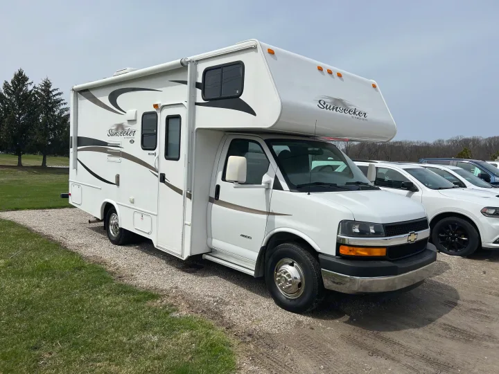White Sunseeker RV rental parked on gravel, ideal for motorhome travel adventures.. Forest River Sunseeker LE 2013