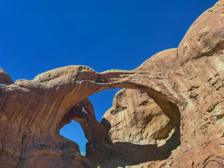 Discover Utah's Double Arch in Arches NP, ideal for an RV rental trip. Red sandstone arches against a clear blue sky await exploration.. Forest River Rockwood Roo 2019