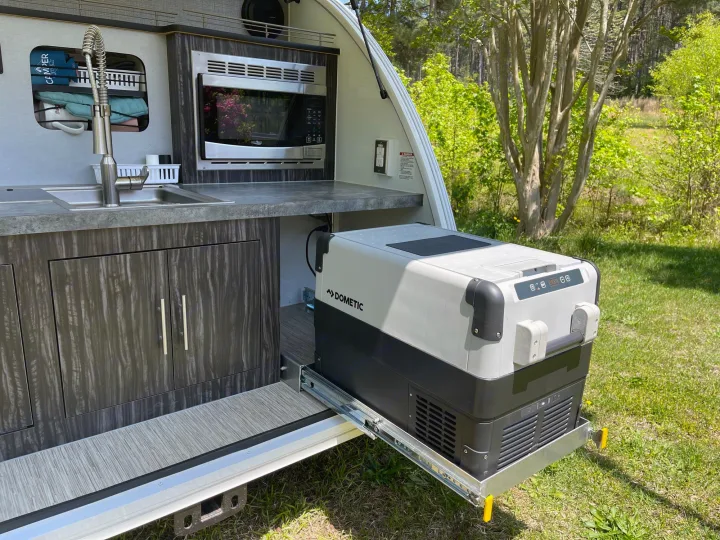 RV rental outdoor kitchen with sink, microwave, and Dometic pull-out fridge, ideal for convenient camping.. InTech RV InTech RV Trailer 2018