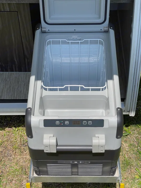 An open portable RV refrigerator/freezer on a slide-out tray, ready for an RV rental adventure.. InTech RV InTech RV Trailer 2018