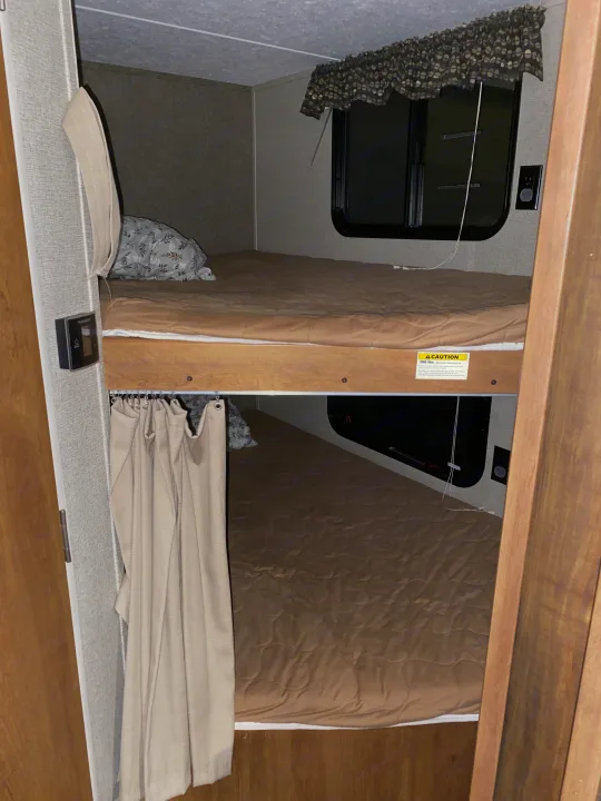 This RV rental features two cozy bunk beds with quilted mattresses, a Dometic control, and a window, ideal for extra sleeping.. Keystone RV Springdale 2017