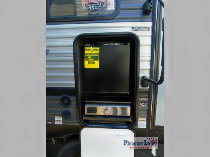 Explore this RV rental's convenient outdoor kitchen, featuring a mini-fridge and grill on the side of the recreational vehicle.. Forest River Salem 2021