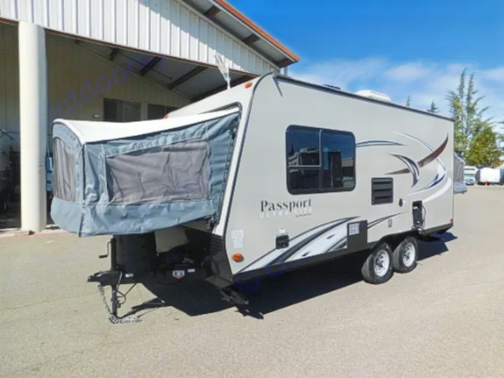 Gray Passport Ultra Lite hybrid RV rental. Expandable tent bunk is open. Perfect for camping adventures!. Keystone RV Passport Express 2016