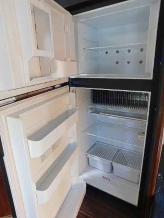 Empty, clean RV rental fridge, ready for your food & drinks. Essential for any trip!. Keystone RV Passport Express 2016