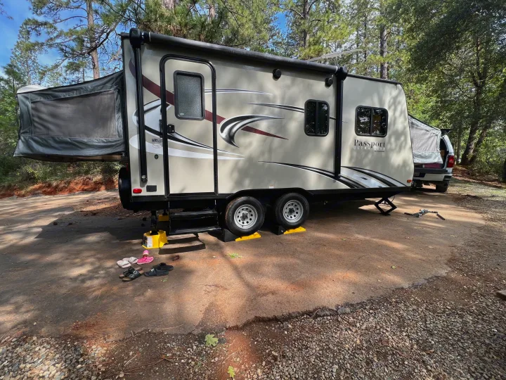 This RV rental, a travel trailer with extended pop-out beds, is perfectly set up for camping with leveling blocks and stabilizers.. Keystone RV Passport Express 2016