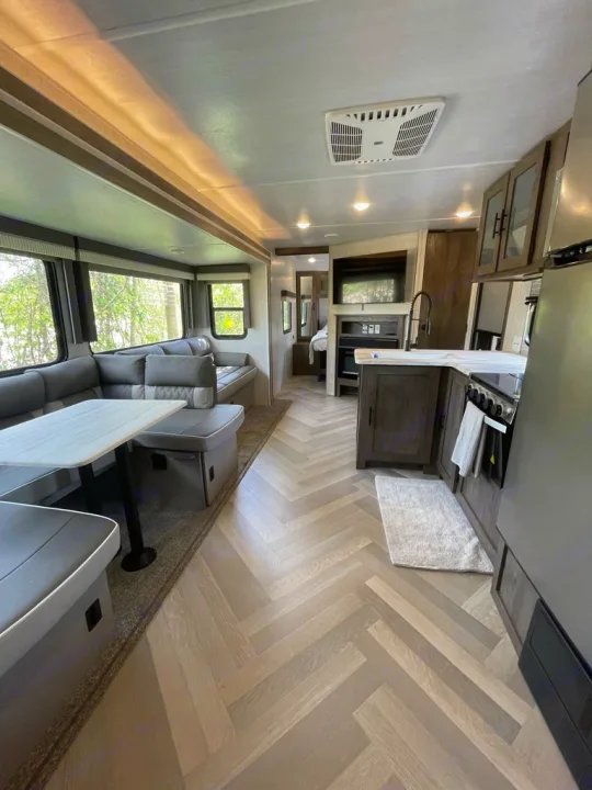 Spacious RV rental interior with modern living area, dinette, and full kitchen. Ideal for travel comfort.. Forest River Other 2021