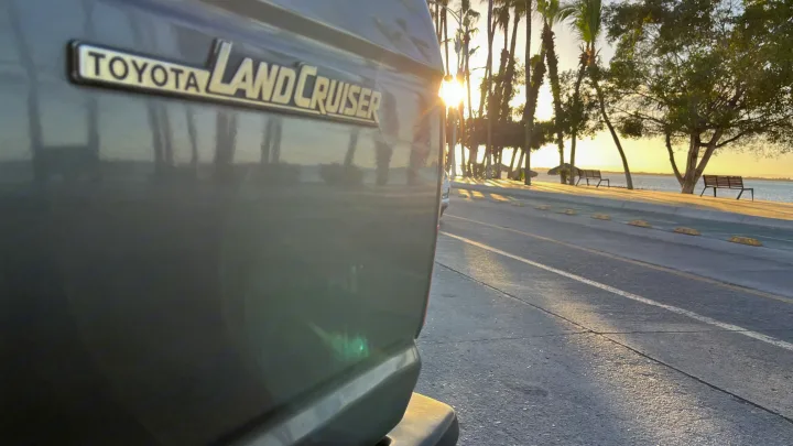 Golden sunset over the sea, seen from a Toyota Land Cruiser. Perfect road trip vehicle; consider an RV rental for your next adventure.. Toyota LandCruiser HJ61 VX 1989