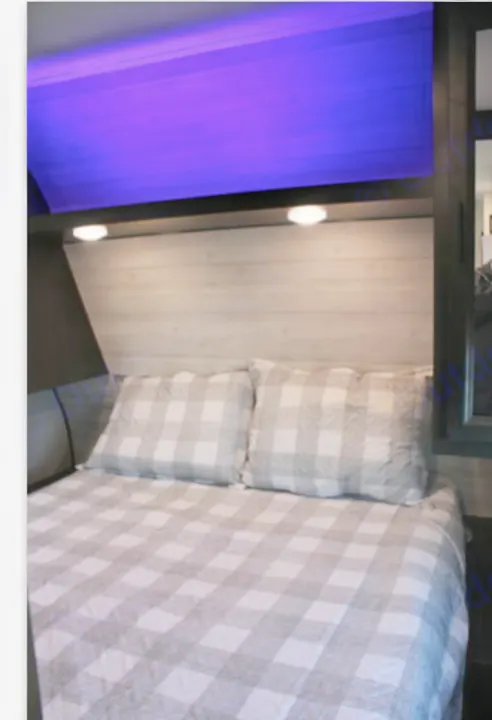 RV rental bedroom: cozy space with gray plaid bedding, wood headboard, and unique purple accent lighting.. Jayco JayFlight 267BHSW 2022