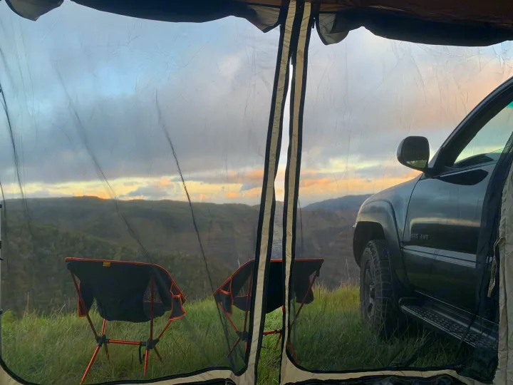 Inside a mesh tent, two chairs face mountains & an SUV. Great RV rental camping spot for scenic views!. Toyota 4runner 2003