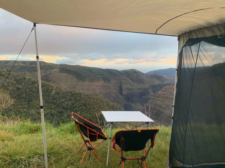 Scenic RV rental adventure! A comfortable camping setup with a table, chairs, and awning overlooks a stunning, expansive canyon.. Toyota 4runner 2003