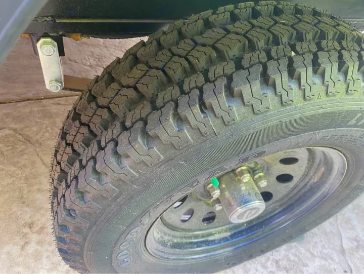 Goodyear all-terrain tire & wheel on an RV rental, showing robust tread and suspension details.. Jayco Jay Flight SLX Baja Edition 2020