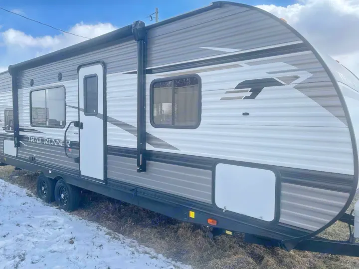 White and grey Trail Runner travel trailer, an ideal RV rental ready for adventure.. Heartland RVs Trail Runner 2022