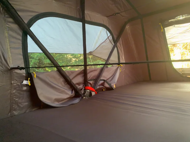 Cozy RV rental tent interior with a dark mattress and screened window, offering tranquil nature views for camping.. Smittybilt Overlander XL Gen 2 RTT 2021