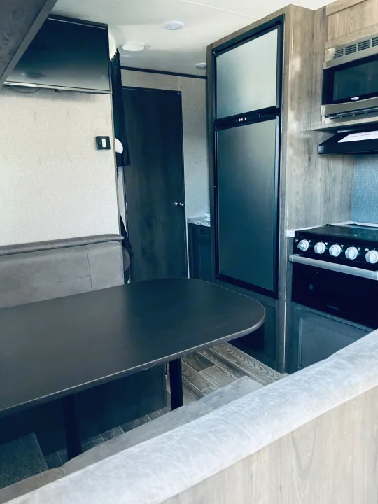 Step inside this spacious RV rental, offering a full kitchen, comfortable dinette, and entertainment with a TV.. Jayco Jay Flight SLX Rocky Mountain Edition 2021