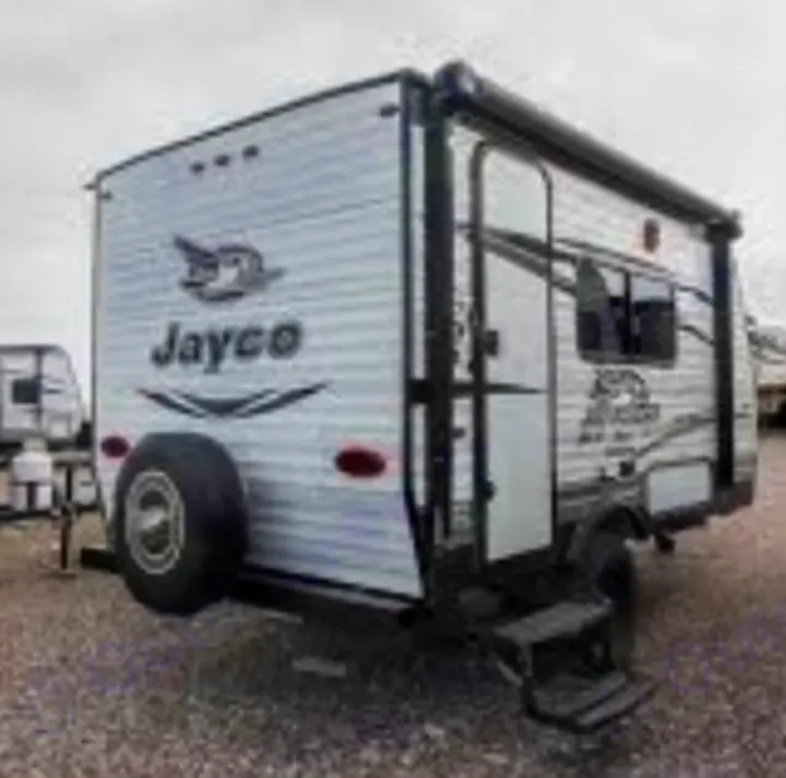 White Jayco travel trailer RV rental, seen from rear-right with spare tire and awning. Ready for camping trips!. Jayco Jay Flight 2016
