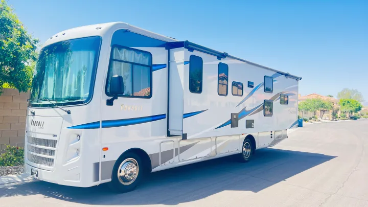 A bright white Coachmen Pursuit RV rental parked under a clear sky, ready for unforgettable travel and vacation memories.. Forest River Coachmen Pursuit 2022