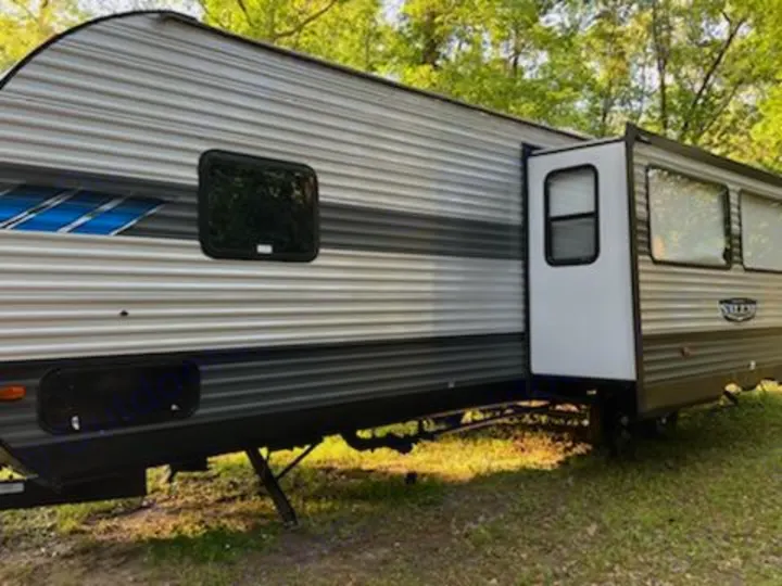 This modern travel trailer RV rental, with a deployed slide-out section and horizontal siding, is ready for your outdoor escape.. Forest River Salem 2021