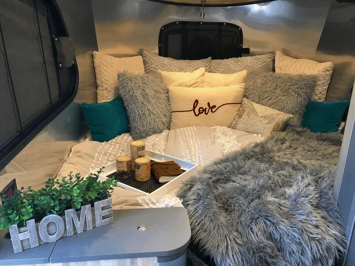 This area conveys to the "living room" with table for eating - we prefer to keep the bed set up and eat outside or right here!. Airstream Basecamp X 2021
