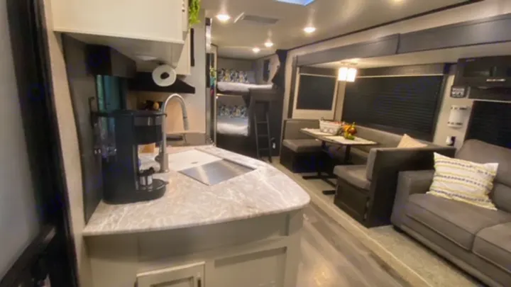 Spacious RV rental interior featuring a full kitchen, dinette, bunk beds, and a comfortable living area.. Jayco Jay Flight 2021