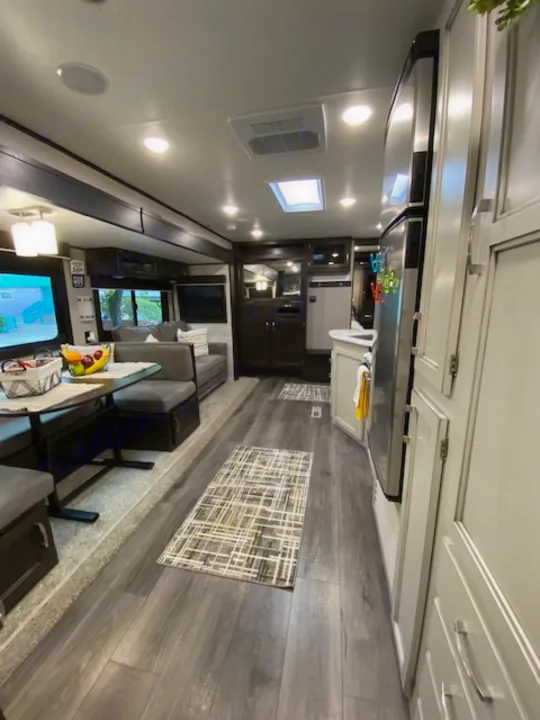 Spacious RV rental interior with modern kitchen, living area, and wood floors. Perfect for comfortable travel.. Jayco Jay Flight 2021
