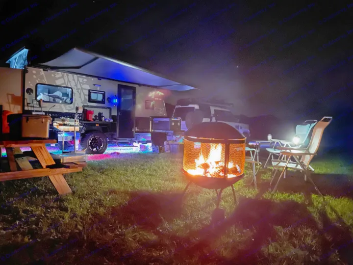 Cozy night camping! This illuminated RV rental with a fire pit and seating creates a perfect outdoor escape. Adventure awaits!. Other Other 2022