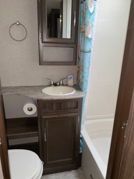 This RV rental features a well-equipped bathroom, including a sink, toilet, vanity, and a tub/shower with a seaside curtain.. Coachmen Other 2019