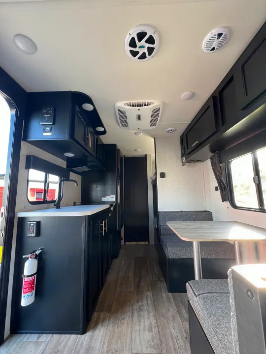 Modern RV rental interior with a well-equipped kitchen, cozy dinette, and essential features for your travel comfort.. Forest River Cherokee Wolf Pup 2022