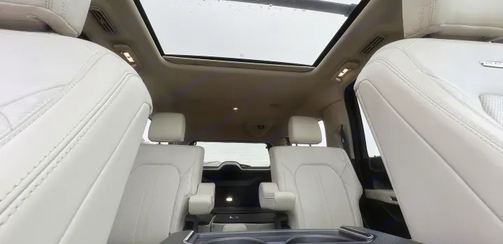 Plush white leather interior of a spacious vehicle with a panoramic roof, offering comfort for any journey, including rv rental trips.. Ford Ford Expedition 2021