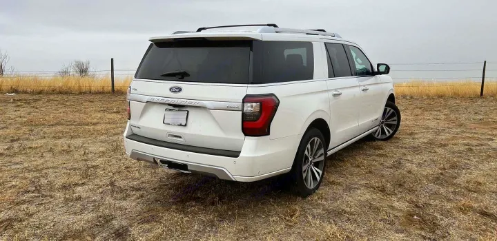 Large white Ford Expedition MAX SUV in a field. Perfect for travel, an alternative to an RV rental.. Ford Ford Expedition 2021