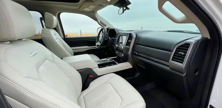 Explore the plush white leather interior of this large SUV, a perfect companion for your next RV rental adventure.. Ford Ford Expedition 2021
