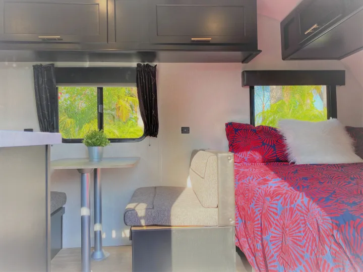 Experience comfort in this RV rental's bright interior. Features dining, cozy bedding, and cabinets in a compact space.. Forest River Cherokee Wolf Pup 2022