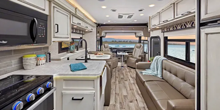 Experience comfort in this modern RV rental interior featuring a full kitchen, sofa, and dinette, with stunning waterfront views.. Jayco ALANTE 27a 2022