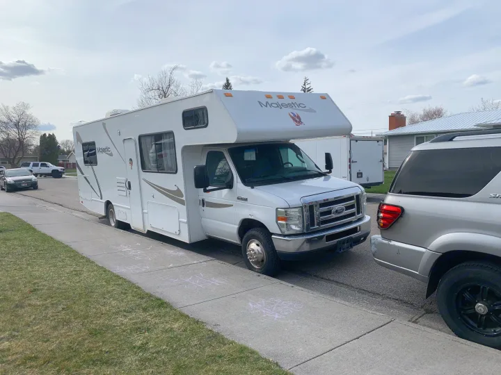A white Majestic RV rental (Ford Class C) parked on a residential street. Chalk drawings are on the sidewalk.. Other Other 2008