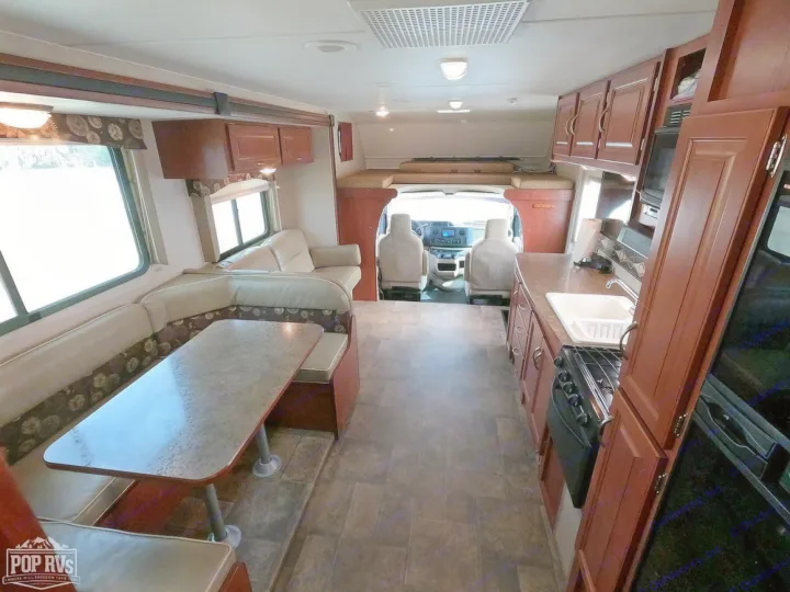 Spacious RV rental interior with full kitchen, dinette seating, comfortable living area, and bunk for travel.. Itasca Spirit 2014