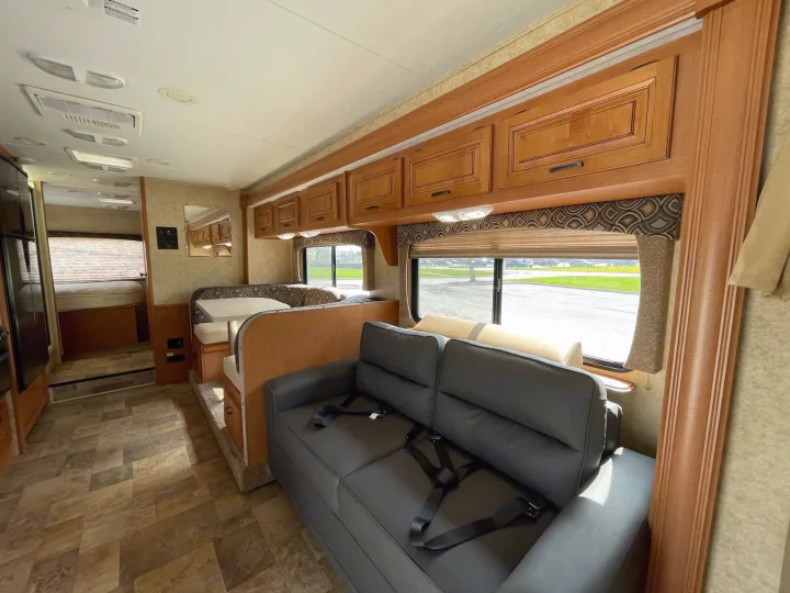 RV rental interior: A bright, inviting living space with a sofa, dinette, and hallway leading to the bedroom.. Forest River Sunseeker 2013