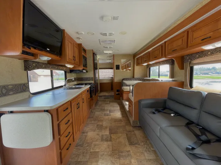 Spacious rv rental interior showing a full kitchen, comfy dinette, and sofa, perfect for your next road trip adventure.. Forest River Sunseeker 2013