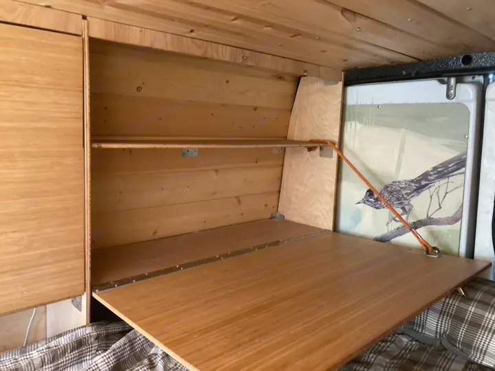 See this RV rental's custom wood interior with a handy fold-down table, shelving, and a detailed roadrunner mural.. Dodge Sprinter 2003