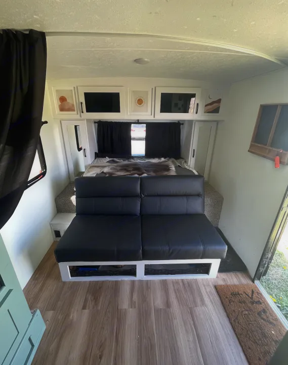 Step into this chic RV rental! Features a black leather sofa, cozy bed, modern cabinets, and wood flooring for your journey.. Forest River Coachmen Apex Nano Off-Grid 2022