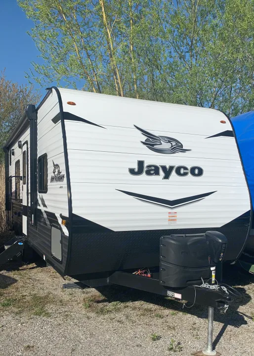White & black Jayco Jay Flight travel trailer, an ideal RV rental. Parked on gravel, ready for adventure.. Jayco Jay Flight 2022