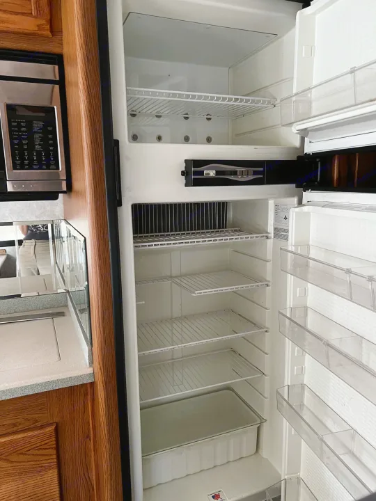Open, clean RV refrigerator/freezer and microwave, ready for your rv rental kitchen. Perfect for storing trip essentials!. Allegro Allegro Bay 2004