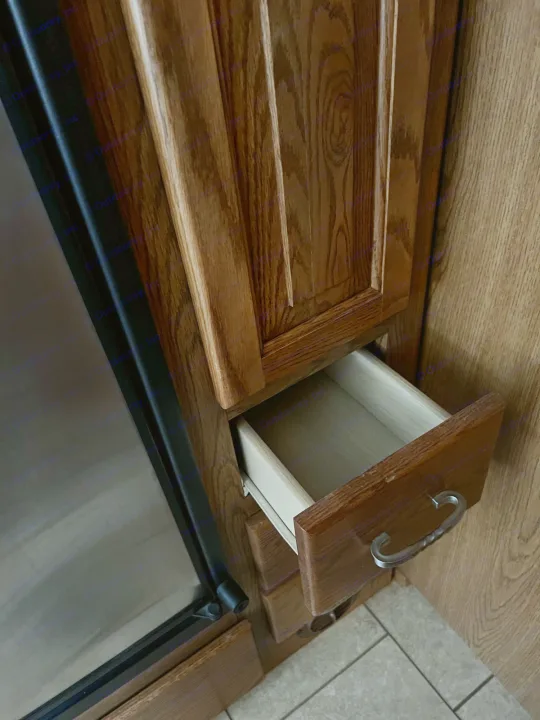 RV rental kitchen interior: oak cabinets, a stainless steel fridge, and an open drawer. Perfect for travel storage.. Allegro Allegro Bay 2004