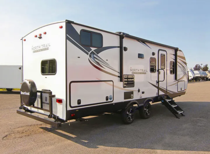 Heartland North Trail travel trailer shown, ready for your next rv rental adventure. Ideal camper for road trips.. North Trail 24bhs 2021