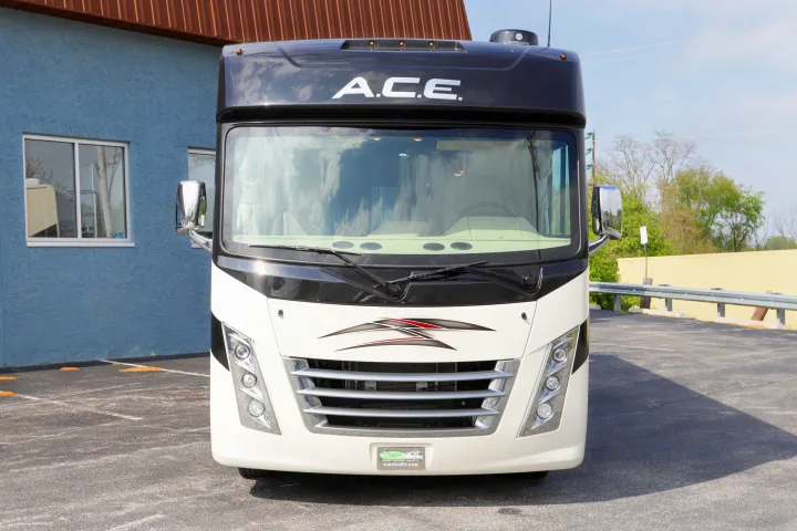Front view of a white and black ACE motorhome, an excellent RV rental choice, parked on asphalt.. Thor Motor Coach A.C.E 2022