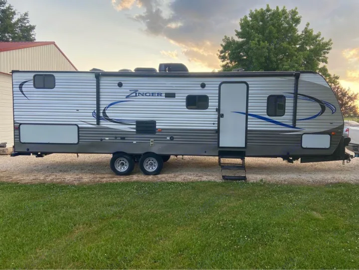 Entrance, awning, outdoor kitchen at the rear hatch and additional storage in the front hatch.. Crossroads RV Zinger 2018