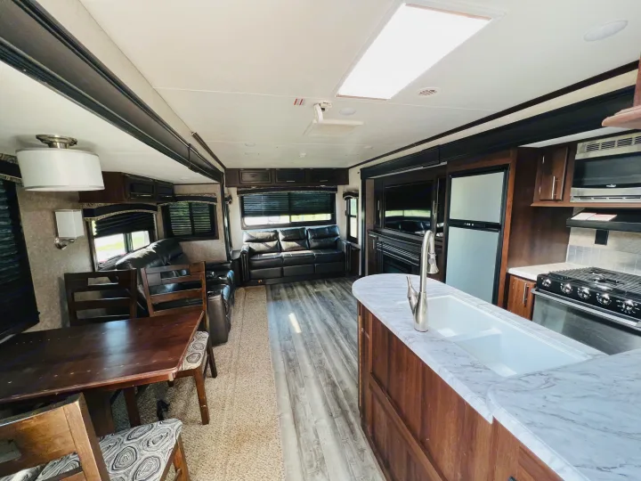 Spacious RV rental interior featuring a modern living area with sofas, kitchen, and dining table.. Jayco Jay Flight 2019