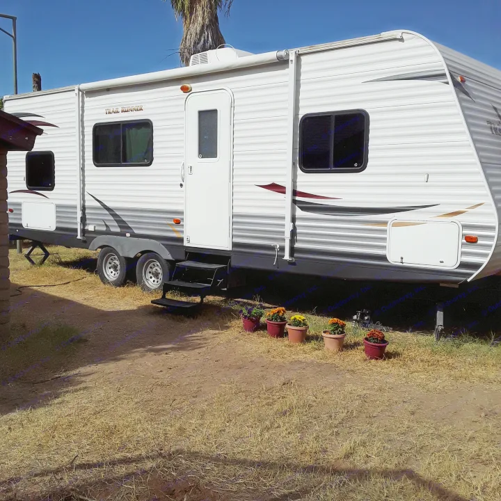 Experience freedom with an RV rental! This modern travel trailer is ready for your next adventure, parked on a sunny day.. Heartland RVs Trail Runner 2013