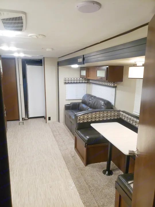 Step inside this cozy RV rental! Features a comfy sofa, U-shaped dinette, kitchen cabinets, and bright interior lighting.. Avenger ATI 2020