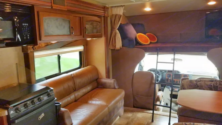 Step inside this comfortable RV rental, featuring a full kitchen, sofa, dining booth, and bunk bed for your travels.. Jayco Greyhawk 2013